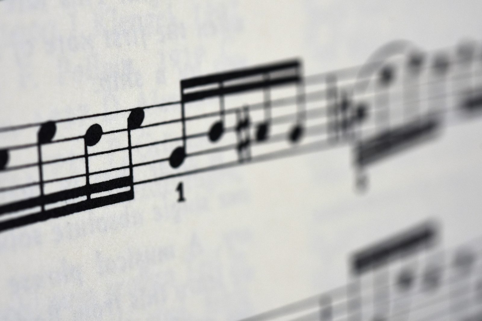Close-up of handwritten violin sheet music catching soft light.